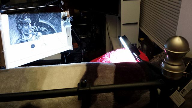 Front view, my LED clamp lamp is clamped to my bed frame and sits over my shoulder